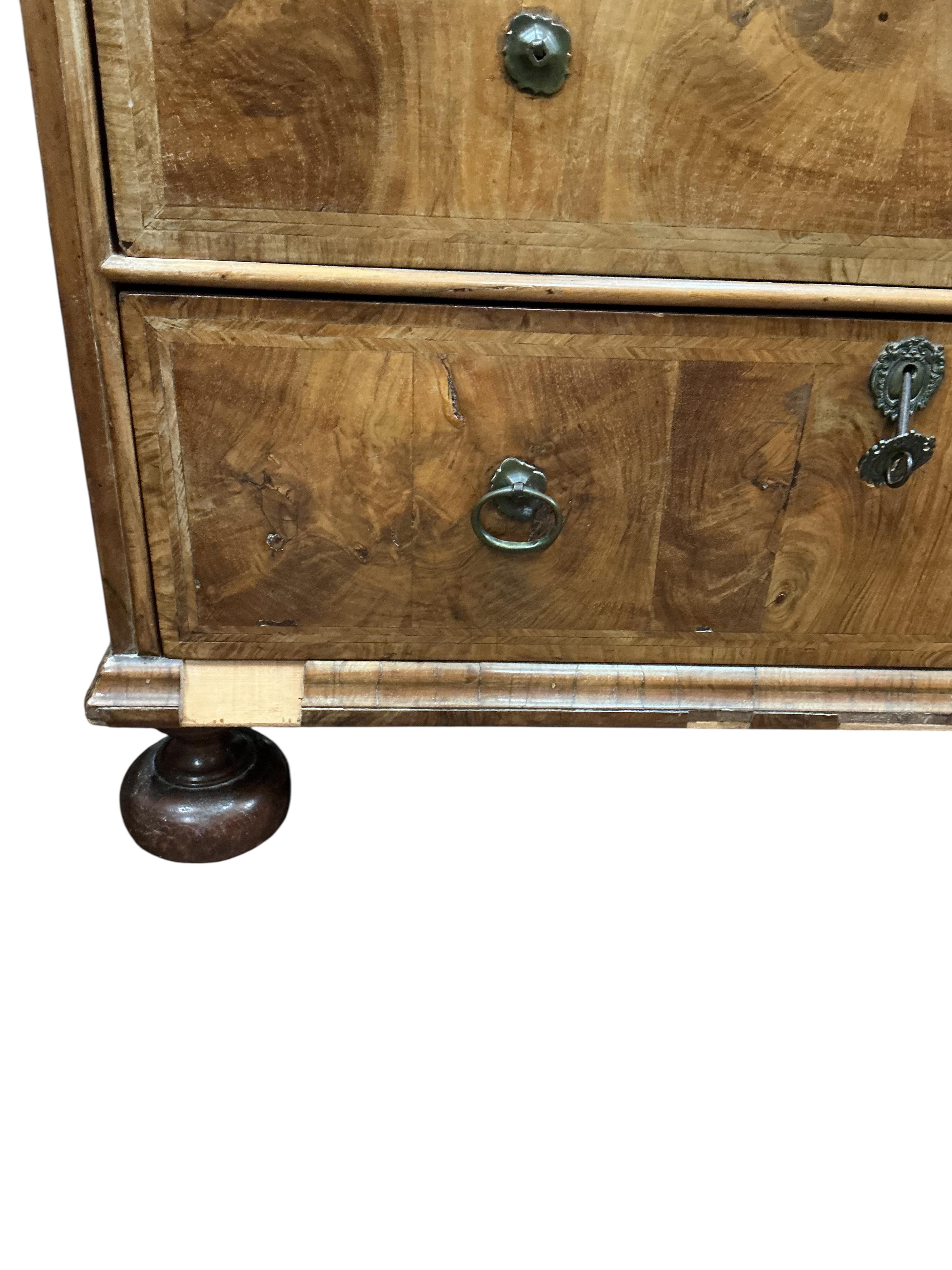 An early 18th century feather banded walnut chest, damaged, width 95cm, depth 54cm, height 91cm